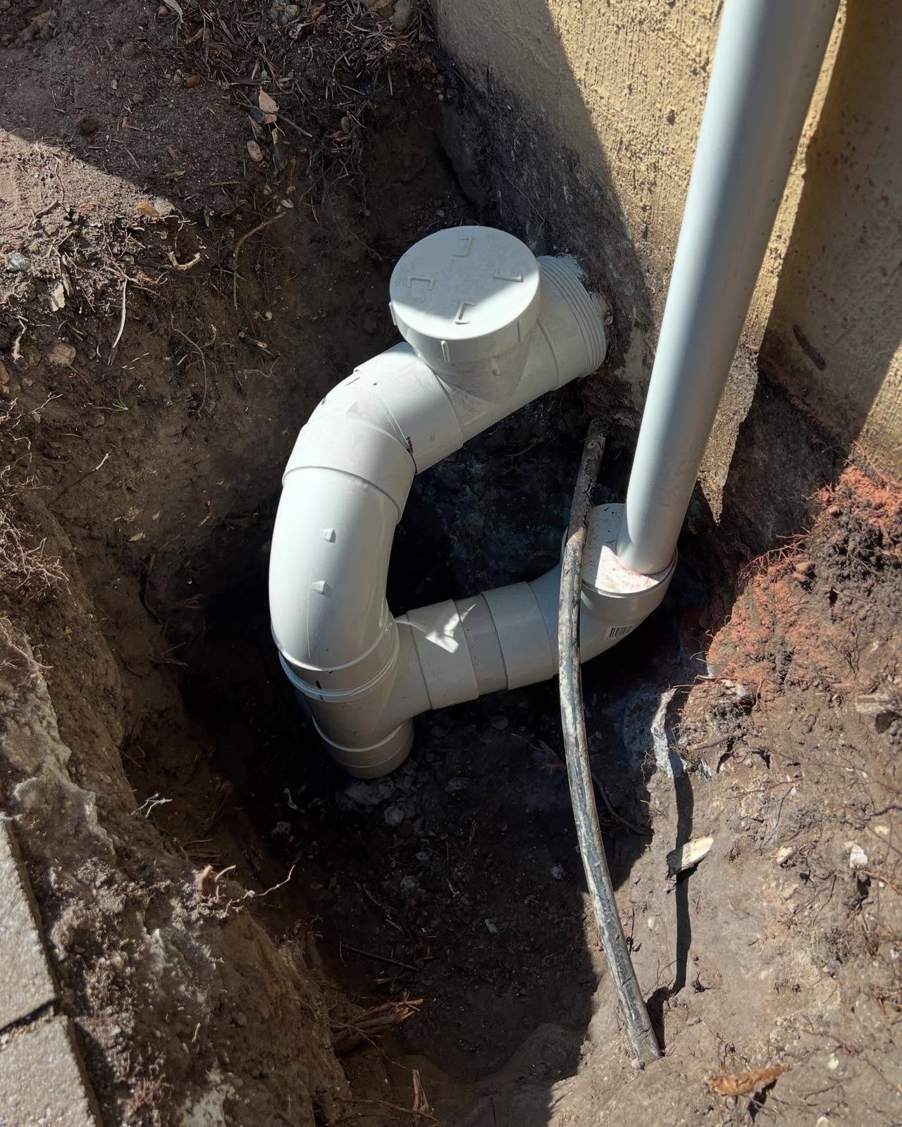 New PVC storm water bend and inspection opening in an open trench